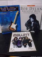 Front covers of Bob Dylan and Eagles songbooks with Mullett photo
