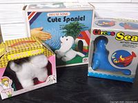 Front view of all three boxed toys: Cute Spaniel, Lovely Judy, Circus Seal