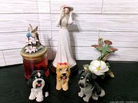 Group shot of all six figurines and candle jar