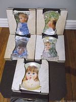 Five boxed collector plates visible in open carton