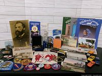 Full layout of assorted pins, patches, documents, magazines, bottle and small items