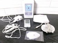 All components laid out: BM8ML unit, adapters, cables, electrodes, manual, box