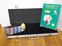 Open aluminum poker chip case, Deluxe Poker Set box leaning against case