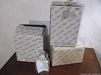 Three Princess House boxed items labeled 497, 453, 002A with unboxed lidded jar