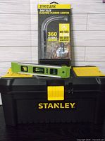 Toolbox closed with level on lid and lighter in packaging