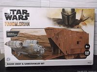 Front of sealed kit box showing artwork, title, piece count and age rating