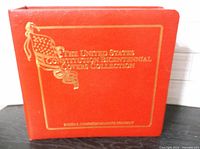 Front of red binder showing gold title text