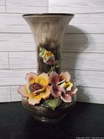 Front view of porcelain vase showing applied roses and overall shape