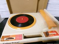 Top view showing turntable, tone arm, controls and included record