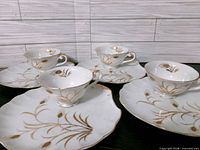 Four plates and four cups displayed