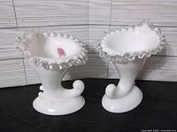 Both Fenton milk glass SilverCrest cornucopia vases front view