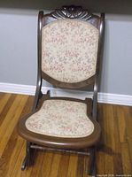 full view of folding rocking chair showing wood frame and tapestry upholstery