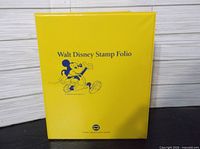 Front of yellow Walt Disney Stamp Folio binder