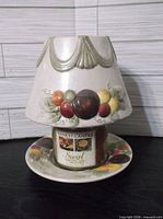 Shade on jar candle sitting on plate holder