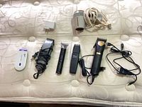 Hair grooming devices hair dryer chargers laid on mattress