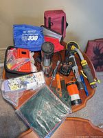 Overview of all items on table including detectors, flashlights, radio, spa kit, cables