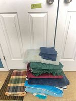 Stacked towels, tablecloths and bamboo placemats