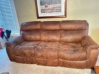 front view of brown microfiber three-seat reclining sofa