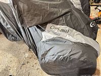 Overall view of black/gray cover showing Can-Am logo on side panel