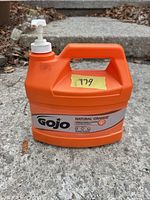 Front view of Gojo Natural Orange pumice hand cleaner jug with pump