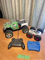 Monster truck, flip car, two controllers on table