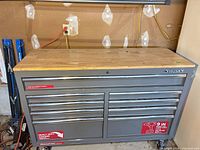 Front view of Husky gray 9-drawer rolling tool chest with wood top and casters