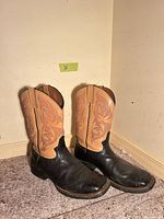 Side view of both boots showing two-tone color and overall wear