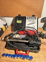 Open case showing red King Canada rotary tool, flexible shaft, bits, manual