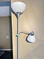 Full view of silver floor lamp with two shades