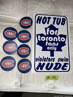 Toronto Maple Leafs hot-tub sign with six Canadiens coasters visible