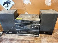 Front view of Panasonic stereo unit flanked by two speakers