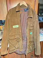 Front view of brown corduroy Polo Ralph Lauren field jacket on hanger