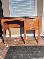 Front view showing drawers, legs, overall structure