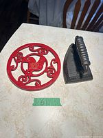 Sad iron and red rooster trivet side by side