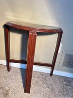 Full view of demilune side table against wall