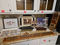 Countertop view of all wall art, signs, tray and tiles
