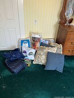 Group showing air mattresses, packaged bedding, decorative pillows