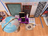 Overall view showing globe, map, chalkboards, cushions, decorative panels