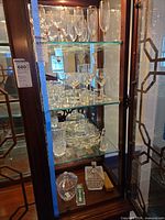 Full cabinet view showing all stemware and serveware on three shelves