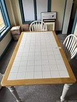 Top view of ceramic tile dining table and partial chairs