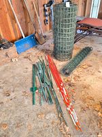 Overall lot showing fencing rolls, posts, rods and marker sticks