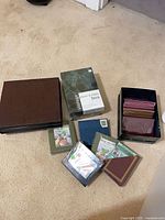 Group on carpet showing large albums, storage box, bin with sleeves