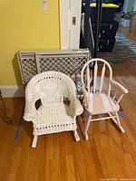 Front view of both rocking chairs and folded gate
