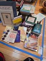 Assorted religion and self-help books, book rack, two matted prints
