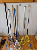 Group shot showing all eight sticks and shafts leaning against wall
