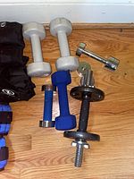 Mixed dumbbells and adjustable spin-lock dumbbell with plate on floor