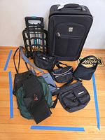 All items laid out: suitcase, cart, six small bags