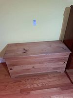 Front view of closed solid wood storage trunk