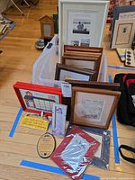 Overview of tote containing multiple framed prints and plaques