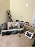Group shot of all seven framed artworks leaning against wall